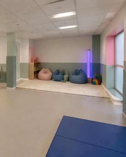 The sensory corner at our centre, with beanbags on a soft rug and a glowing bubble tube